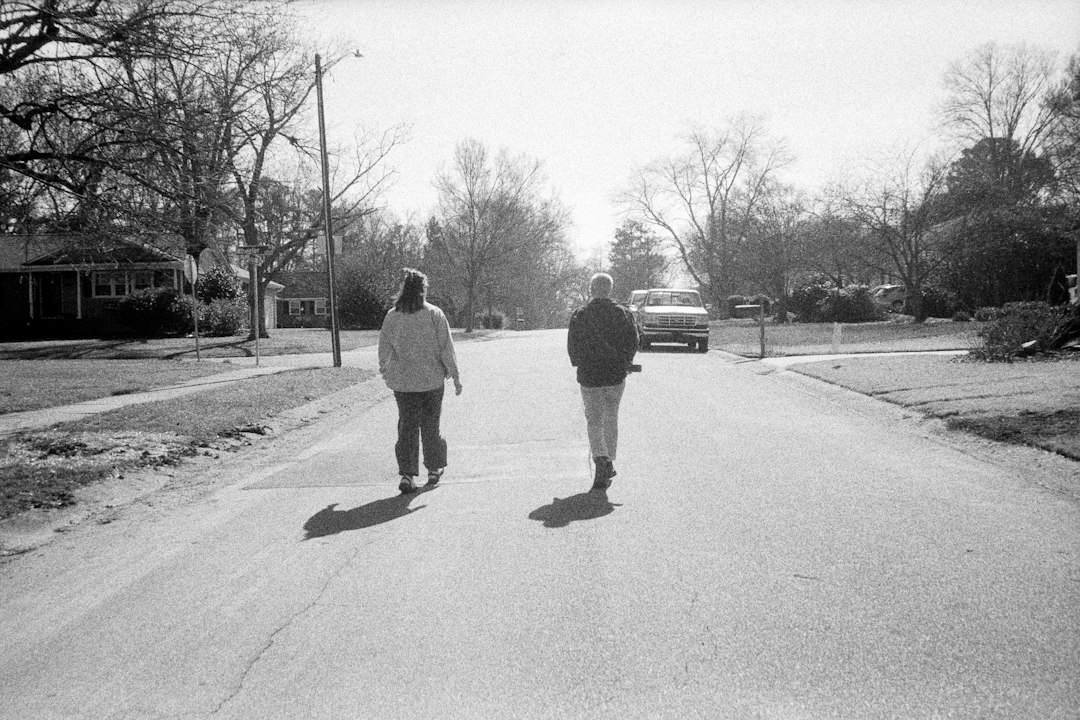 People walking along a residential neighborhood street